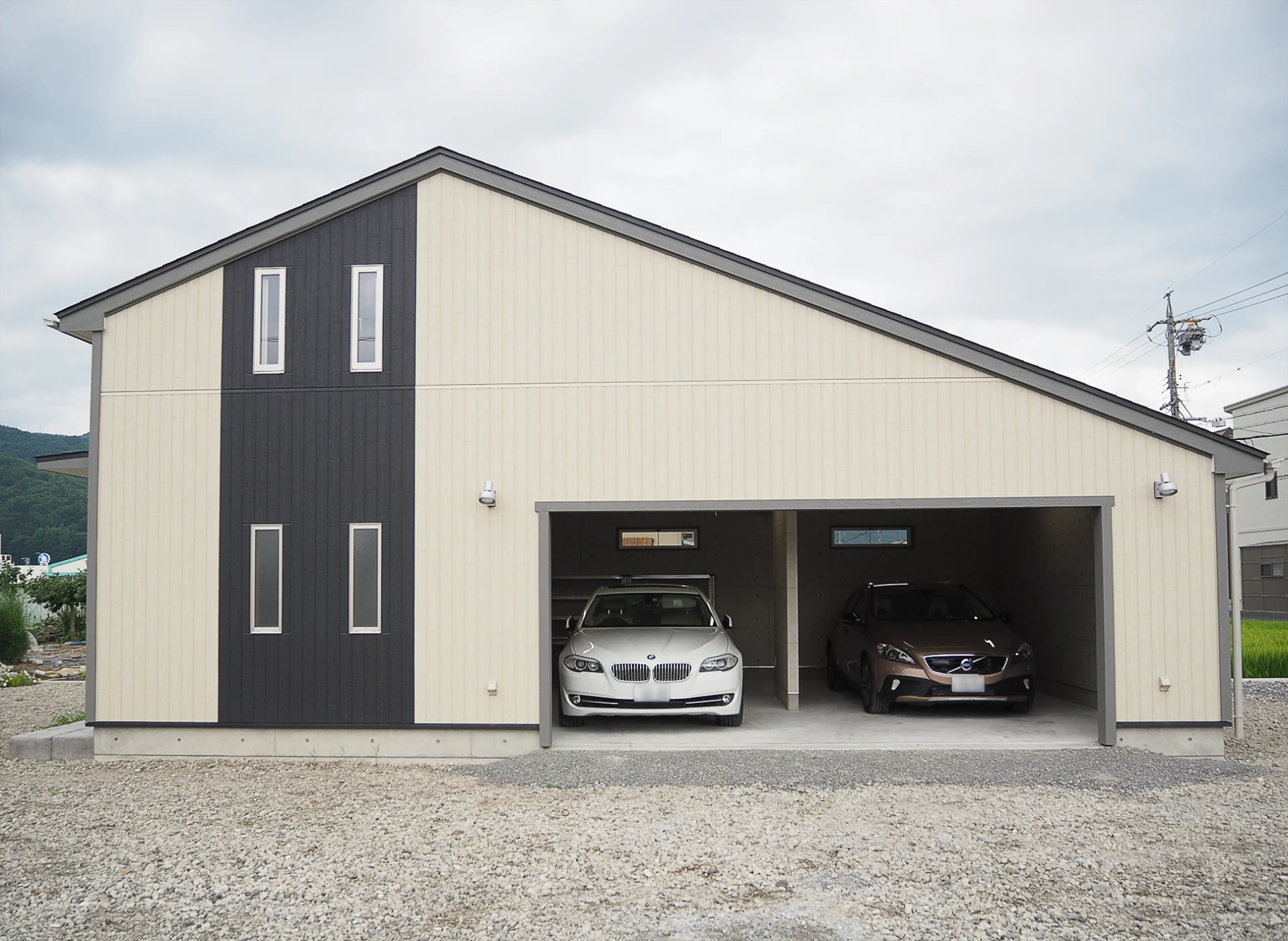 ツートーンのミニマルな外観のガレージ